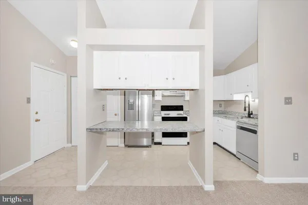 a kitchen with granite countertop stainless steel appliances and sink