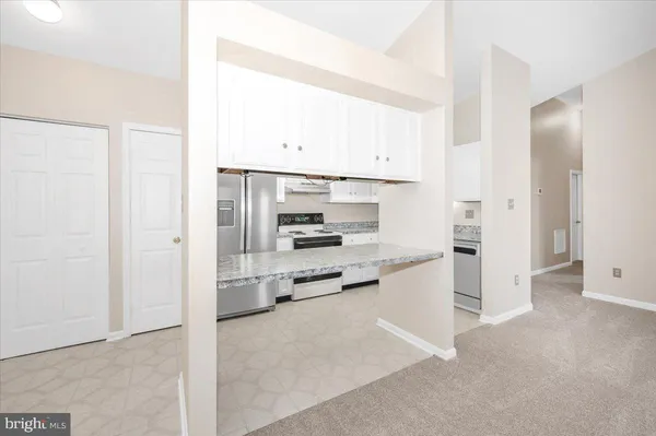 a kitchen with cabinets appliances a sink and a stove