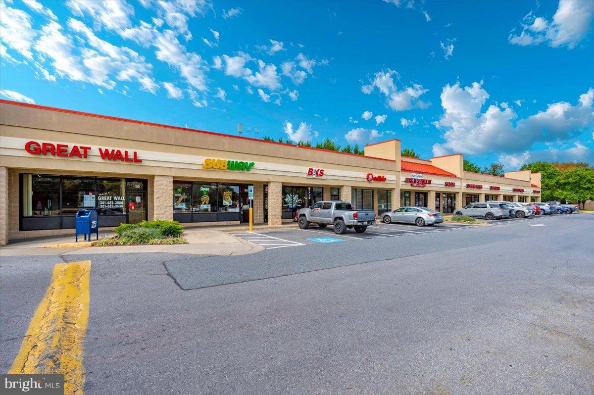 2129 Wainwright Court, Unit 2D Frederick, MD 21702 - Photo 55 of 57 Vibrant shopping plaza under a blue sky.