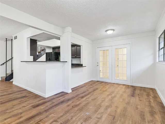 a view of a kitchen with wooden floor and electronic appliances