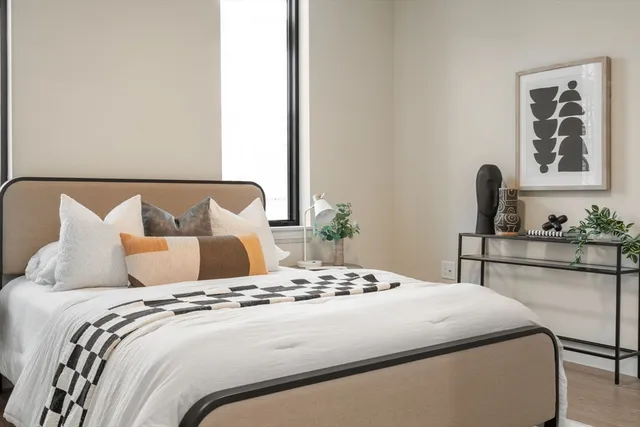 a bedroom with a large bed and a window