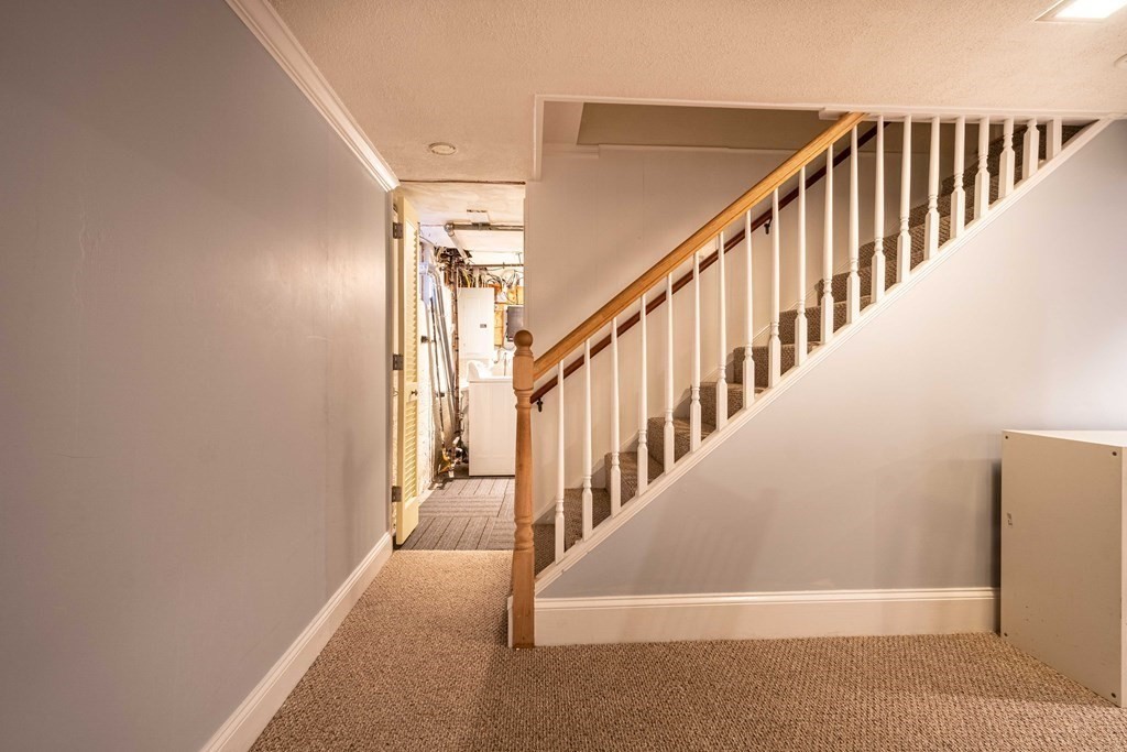 36 Sylvester Road Natick, MA 01760 - Photo 18 of 30 a view of staircase with lots of frames on wall and a window