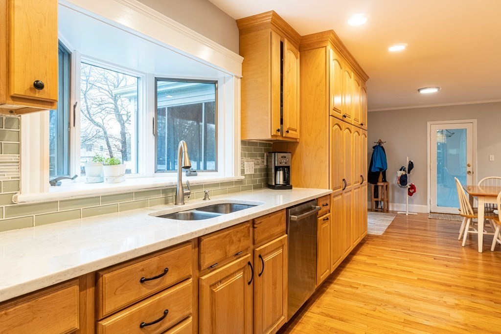 36 Sylvester Road Natick, MA 01760 - Photo 5 of 30 a large kitchen with kitchen island a large window a sink and cabinets