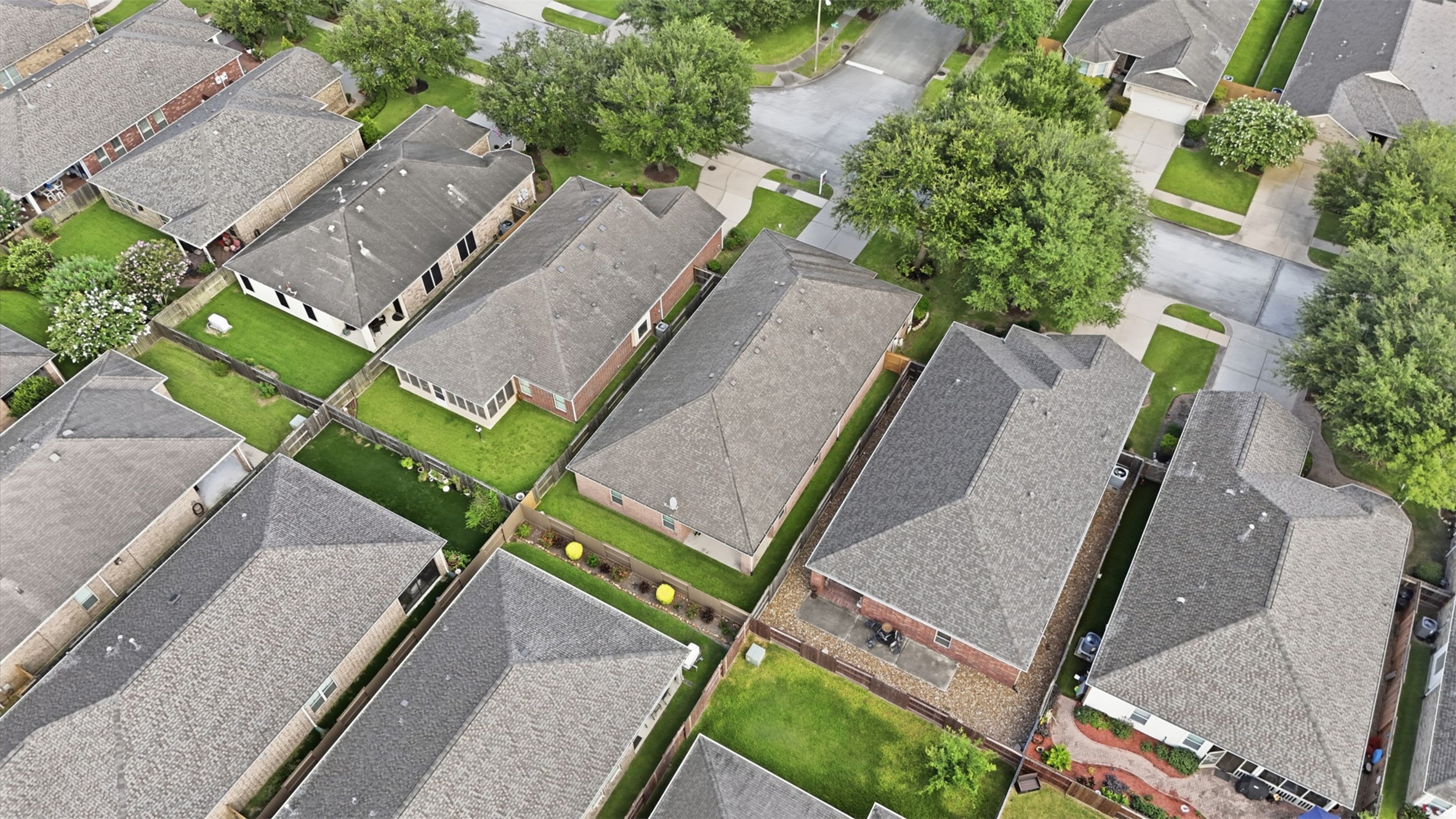 721 Rufina Street League City, TX 77573 - Photo 28 of 33 Another aerial perspective highlights the home's location within this established community, emphasizing the surrounding mature trees and attractive neighborhood setting. The well-planned layout provides both privacy and easy access to nearby community amenities.