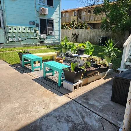 a view of a backyard with sitting area and tub