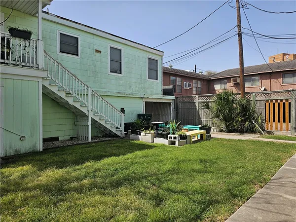 a view of a house with a yard and sitting area