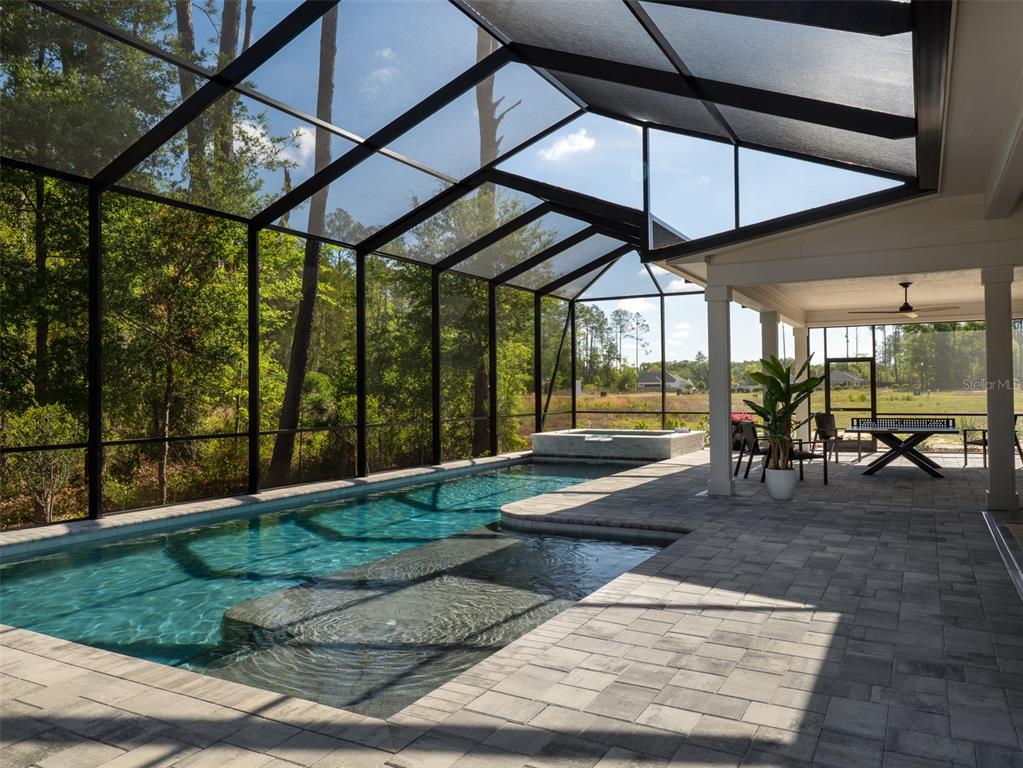14828 Southwest 9th Lane Newberry, FL 32669 - Photo 45 of 45 a view of a patio with a table and chairs under an umbrella