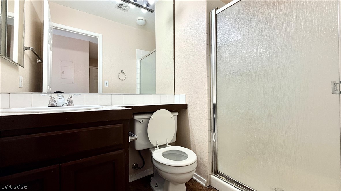 6250 West Flamingo Road, Unit 4 Las Vegas, NV 89103 - Photo 34 of 45 This bright bathroom features a spacious shower and a vanity with ample storage.