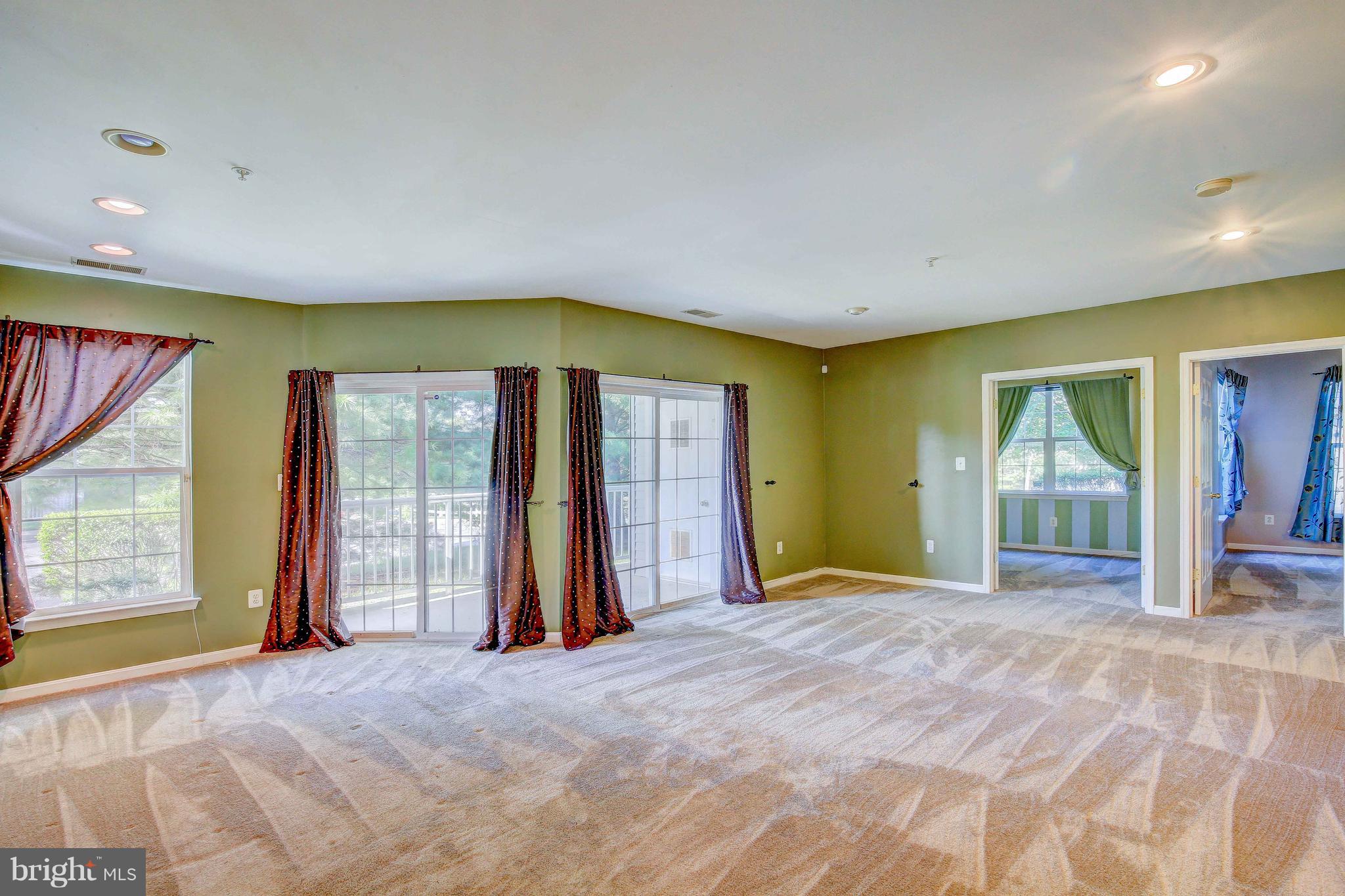 32 Hawk Rise Lane, Unit 102 Owings Mills, MD 21117 - Photo 3 of 34 Spacious living room area with sunlight and Patio