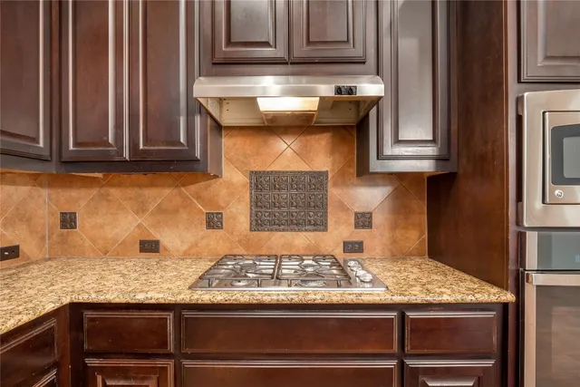 a living room with furniture a dining table and a potted plant