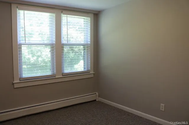 a bathroom with 2 sink toilet and a mirror