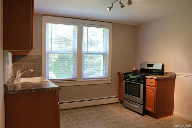 a kitchen with granite countertop cabinets and sink