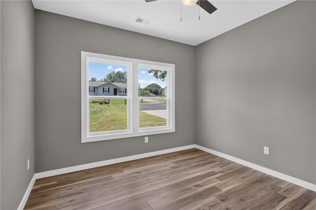 223 Maple Drive Anderson, SC 29621 - Photo 26 of 45 Comfortable room with laminate flooring and ample natural illumination through a dual window setup.