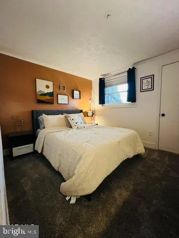 a bedroom with a bed and a night stand