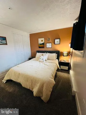 a bedroom with a bed and a night stand