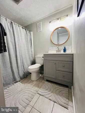 a bathroom with a toilet a sink and a mirror