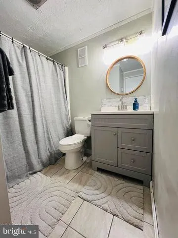 a bathroom with a toilet a sink and a mirror
