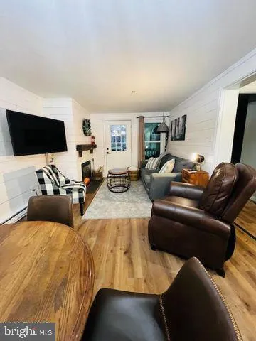 a living room with furniture and a flat screen tv