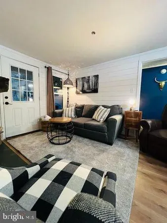 a living room with furniture and a rug