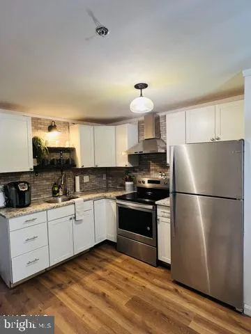 a kitchen with stainless steel appliances granite countertop a refrigerator stove a sink and dishwasher