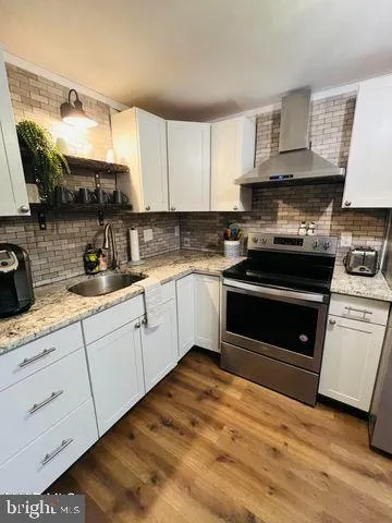 a kitchen with cabinets appliances and a sink
