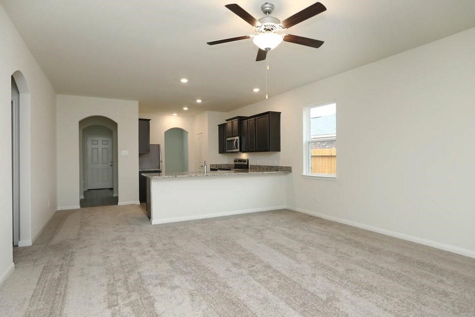 22422 Kennons Way Hockley, TX 77447 - Photo 3 of 11 a view of a livingroom with furniture a ceiling fan and window