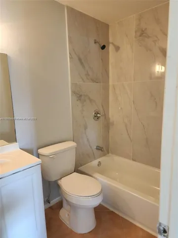 a bathroom with a toilet a sink and bathtub