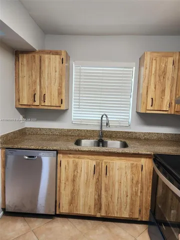 a kitchen with granite countertop a sink and a granite counter tops