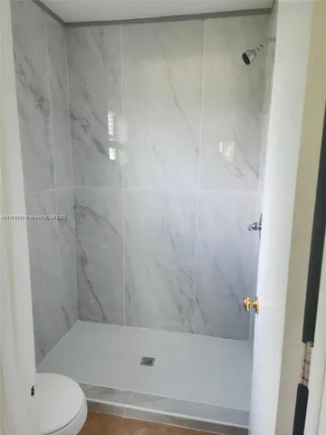 a bathroom with a shower and a toilet