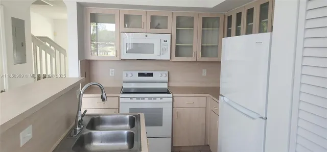 a kitchen with a sink and cabinets