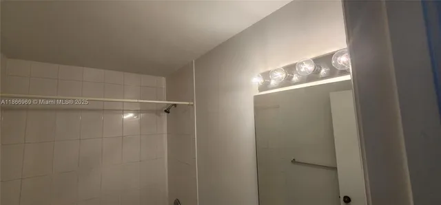 a bathroom with a sink and mirror with toilet