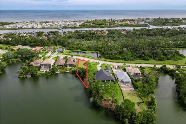an aerial view of a house with a garden and lake view