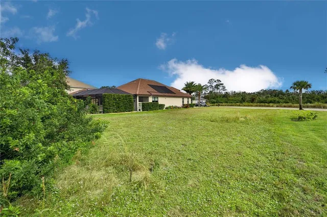 a view of a green field with an ocean view