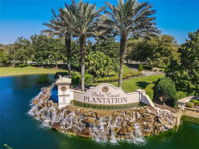 a front view of a house with garden and lake view
