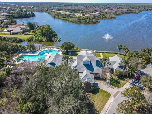 an aerial view of a house with a swimming pool yard and outdoor seating