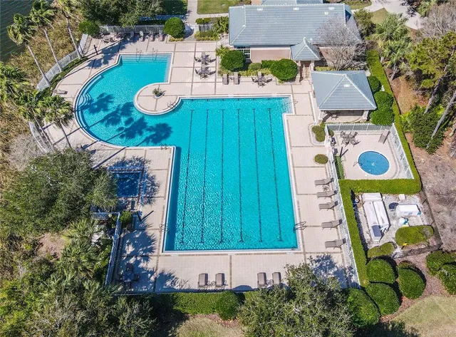 an aerial view of a house with yard swimming pool and outdoor seating