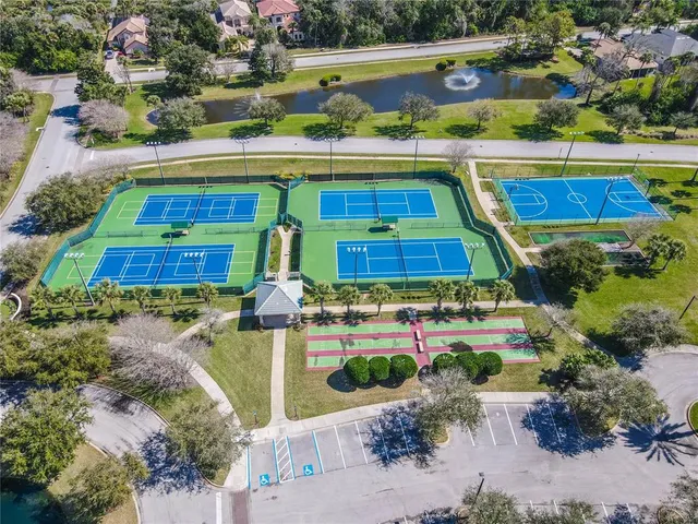 an aerial view of a house with a yard basket ball court and outdoor seating