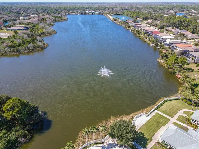 an aerial view of a house with a lake view