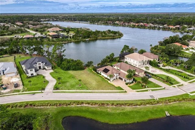 an aerial view of a house with outdoor space and lake view