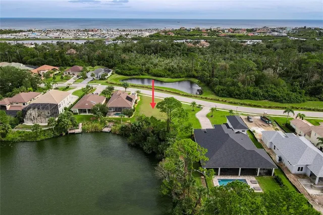 an aerial view of a house with a garden and lake view