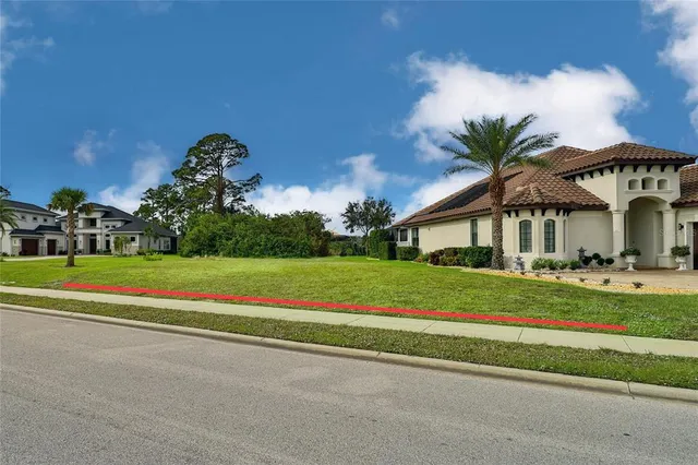 a front view of a house with a big yard and potted plants