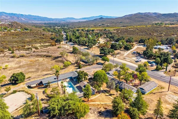 an aerial view of residential houses with outdoor space and street view