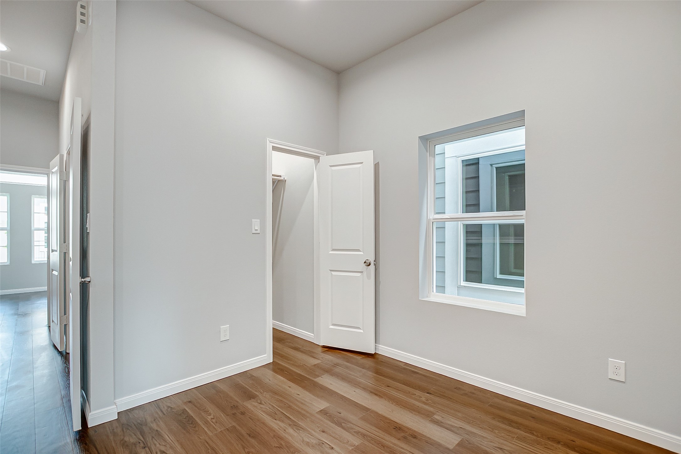 4915 Paradigm Ln Spring Spring, TX 77379 - Photo 14 of 20 an empty room with wooden floor and windows