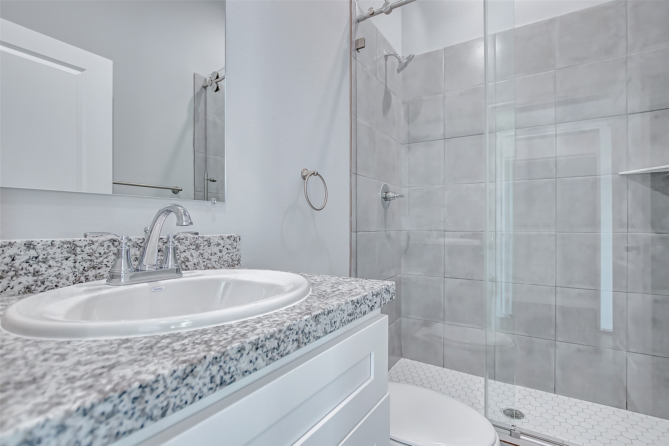4915 Paradigm Ln Spring Spring, TX 77379 - Photo 16 of 20 a bathroom with a granite countertop sink a toilet and shower