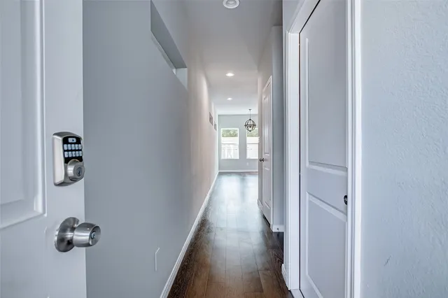 a view of a hallway with wooden floor