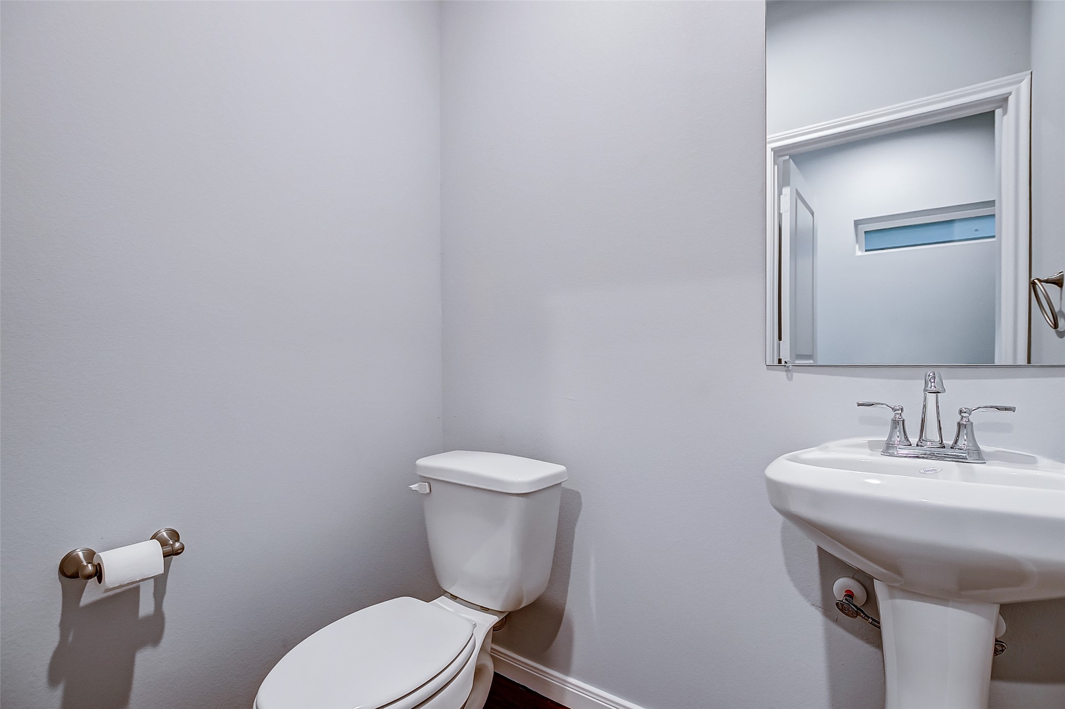 4915 Paradigm Ln Spring Spring, TX 77379 - Photo 4 of 20 a bathroom with a toilet a sink and mirror