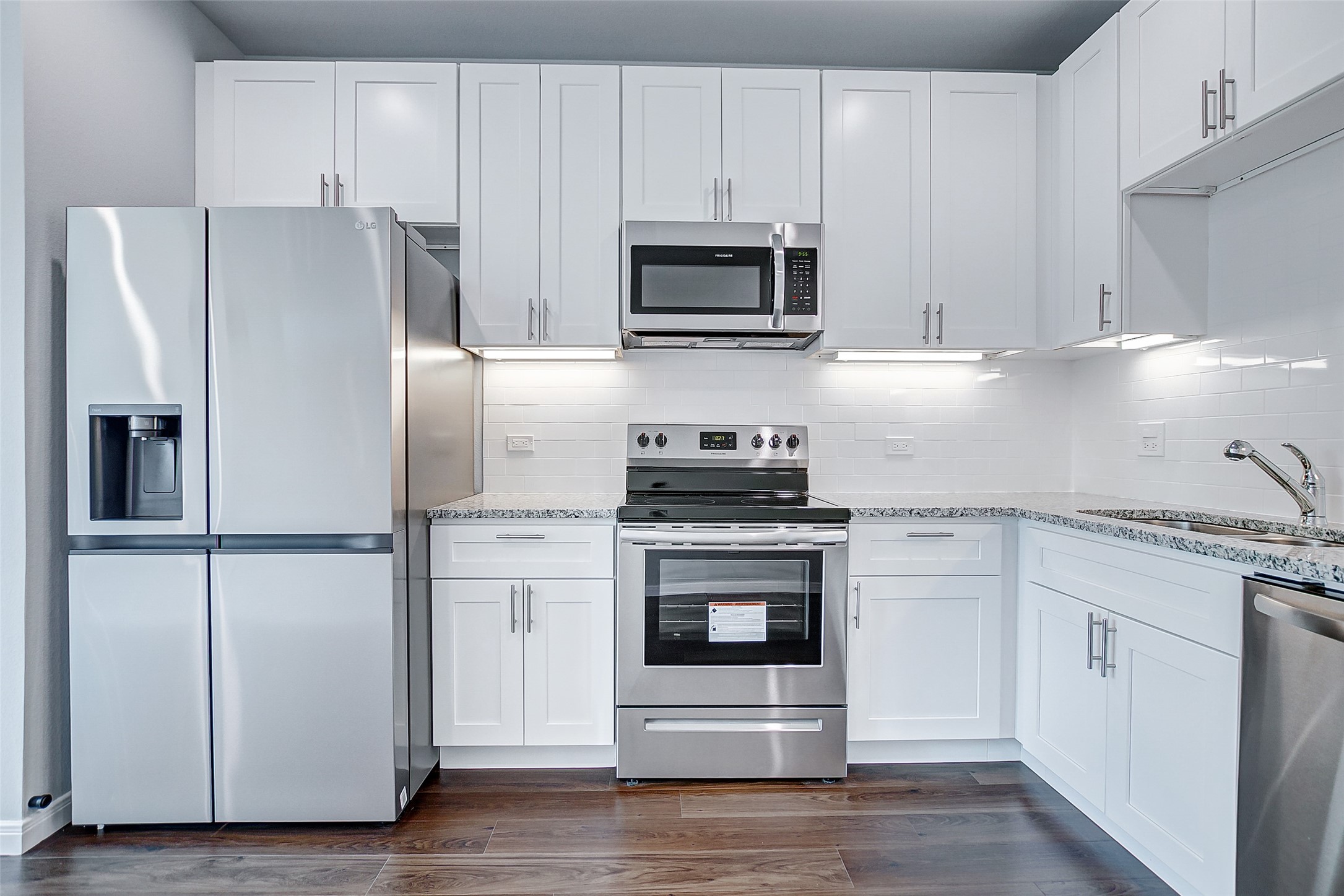4915 Paradigm Ln Spring Spring, TX 77379 - Photo 5 of 20 a kitchen with cabinets stainless steel appliances and wooden floor