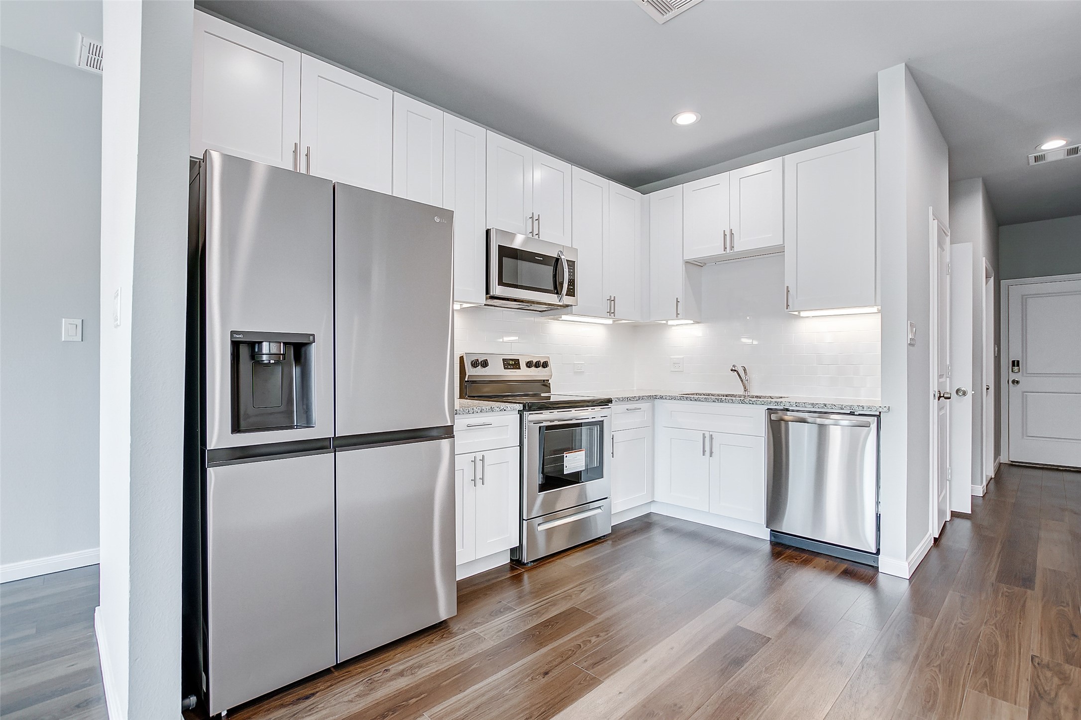 4915 Paradigm Ln Spring Spring, TX 77379 - Photo 6 of 20 a kitchen with stainless steel appliances granite countertop a refrigerator and a stove top oven