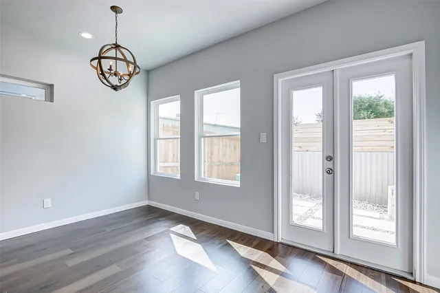 a view of an room with wooden floor and windows