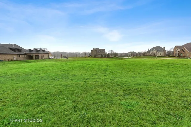 a view of a big yard with a house in the background